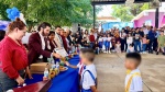 Alumnos graduados junto a su padrino en una ceremonia escolar.